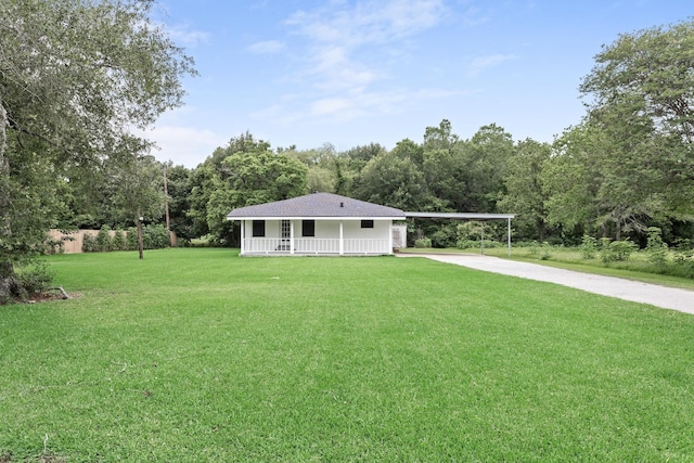 2445 Granger Dr, Bridge City, TX 77611 - view of front of house with concrete driveway, a front lawn, a carport, and covered porch