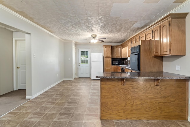2445 Granger Dr, Bridge City, TX 77611 - kitchen featuring black appliances, a peninsula, ceiling fan, a breakfast bar, and dark stone countertops
