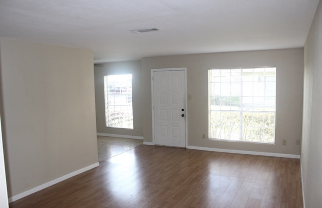 8642 Glen Meadow Ln, Beaumont, TX 77706 - foyer entrance featuring wood finished floors, visible vents, and baseboards