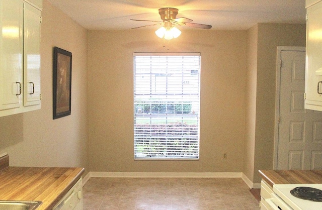 8642 Glen Meadow Ln, Beaumont, TX 77706 - unfurnished dining area with a ceiling fan, baseboards, and light tile patterned flooring