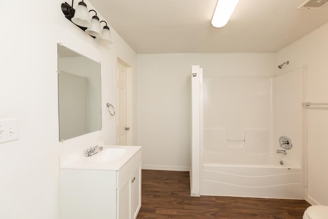 full bathroom featuring wood finished floors, shower / tub combination, vanity, and baseboards