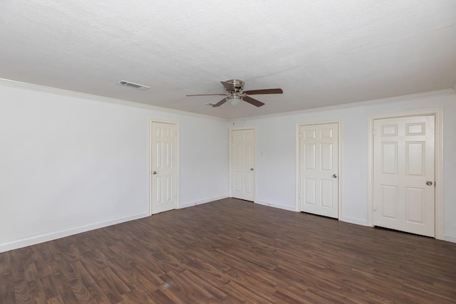 unfurnished bedroom with dark wood-style flooring, baseboards, ornamental molding, ceiling fan, and a textured ceiling