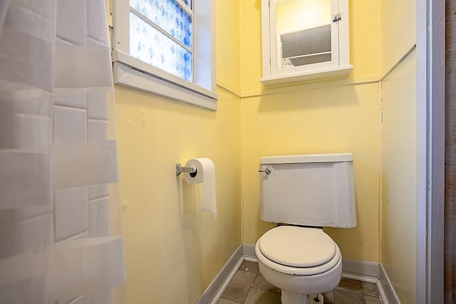 bathroom with tile patterned flooring and toilet