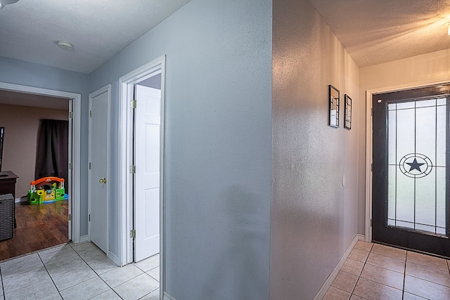 tiled foyer featuring a textured ceiling