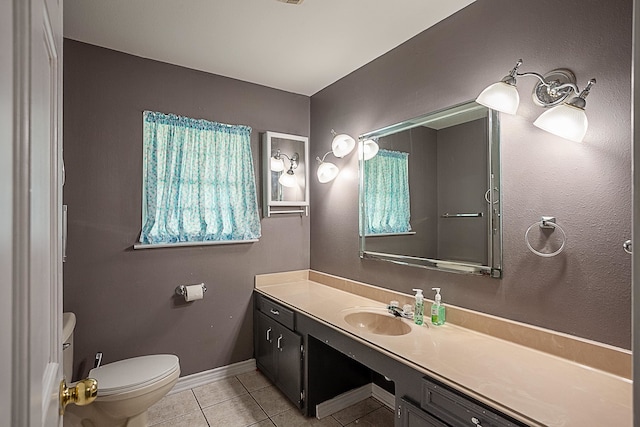 bathroom with tile patterned flooring, vanity, and toilet