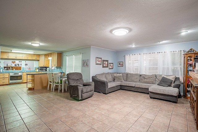 living room with light tile patterned floors and a textured ceiling