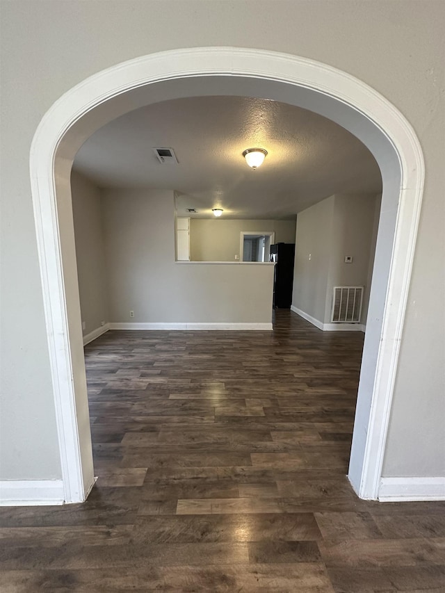 spare room with dark hardwood / wood-style flooring