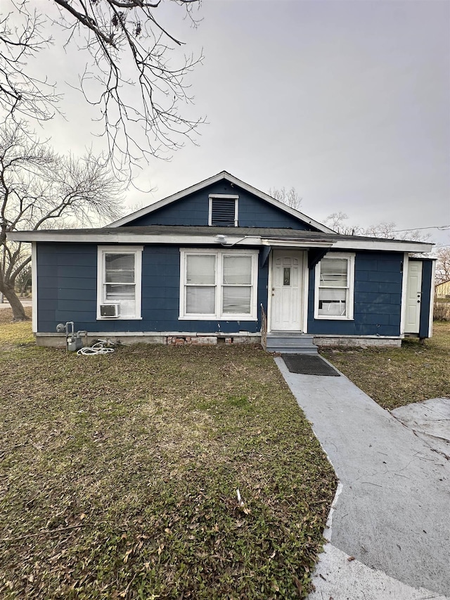 single story home with cooling unit and a front lawn