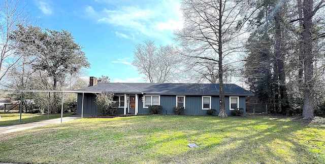 207 Elm St, Silsbee, TX 77656 - single story home featuring a chimney, driveway, an attached carport, and board and batten siding