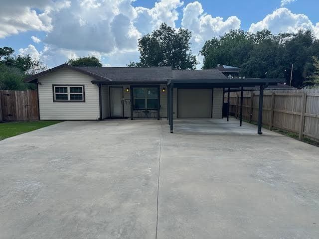 exterior space with a carport and a garage