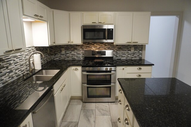 kitchen with white cabinets, light tile patterned flooring, and appliances with stainless steel finishes