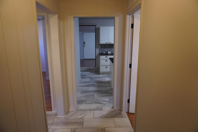 kitchen with white cabinets, appliances with stainless steel finishes, dark stone countertops, and sink