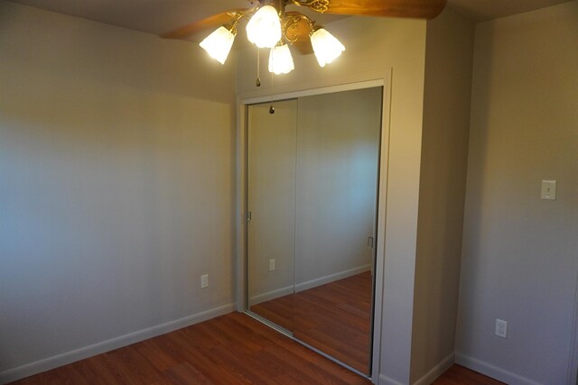 bedroom with dark hardwood / wood-style floors