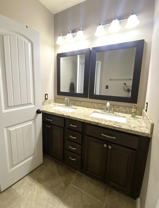 bathroom featuring a sink and double vanity