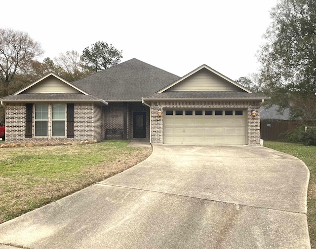 ranch-style house featuring a garage, driveway, brick siding, and a front yard