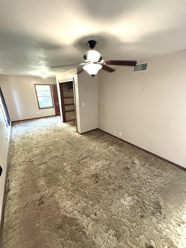 interior space featuring carpet flooring and ceiling fan