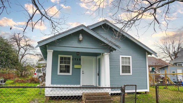 view of front of property with a porch and a lawn