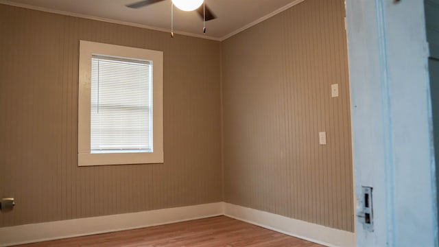 empty room with hardwood / wood-style flooring, ceiling fan, and ornamental molding