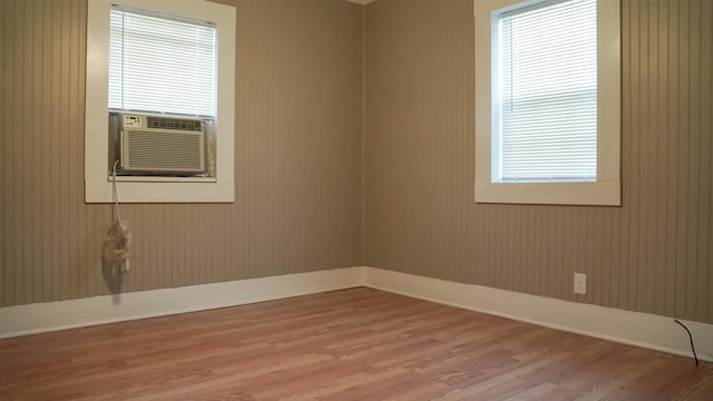 empty room with cooling unit and light hardwood / wood-style flooring