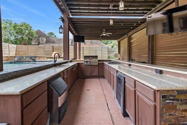 5320 Manion Way, Lumberton, TX 77657 - fenced backyard featuring an outdoor kitchen and wine cooler
