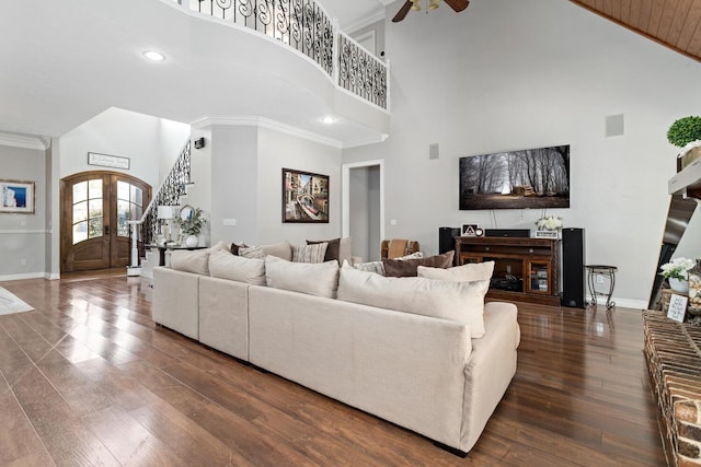 5320 Manion Way, Lumberton, TX 77657 - living area with a towering ceiling, dark wood-style flooring, ceiling fan, ornamental molding, and stairs