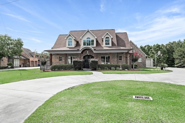 5320 Manion Way, Lumberton, TX 77657 - cape cod-style house with a front lawn, brick siding, and curved driveway
