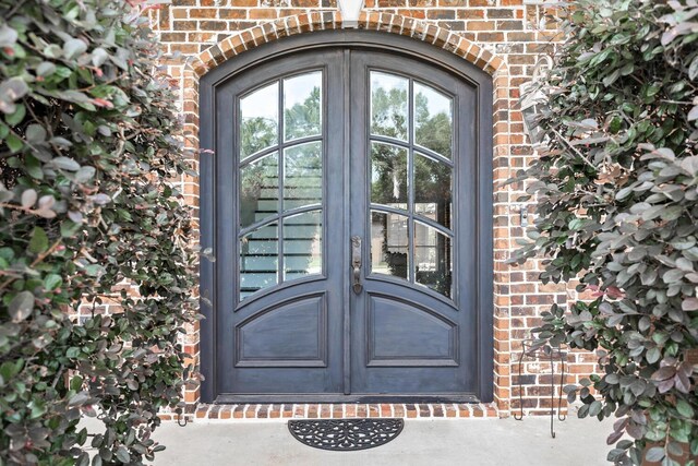 5320 Manion Way, Lumberton, TX 77657 - doorway to property featuring brick siding and french doors