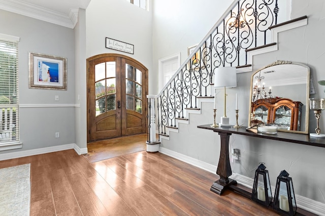 5320 Manion Way, Lumberton, TX 77657 - foyer entrance featuring french doors, plenty of natural light, wood finished floors, stairway, and ornamental molding