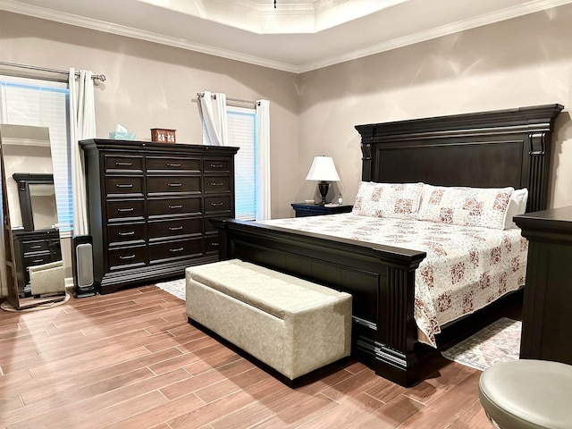 bedroom with a raised ceiling and ornamental molding