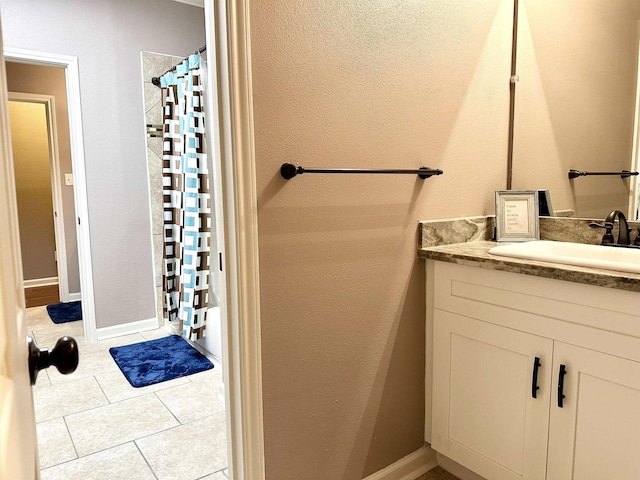 bathroom with tile patterned flooring, a shower with curtain, and vanity