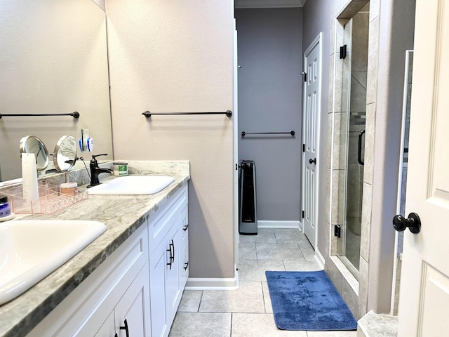 bathroom with tile patterned flooring, vanity, and a shower with shower door