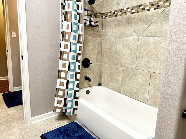 bathroom featuring tile patterned floors and shower / bathtub combination with curtain