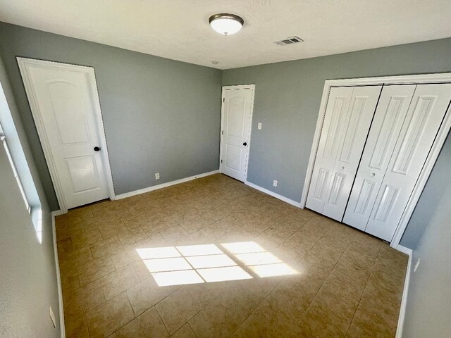 unfurnished bedroom with a closet