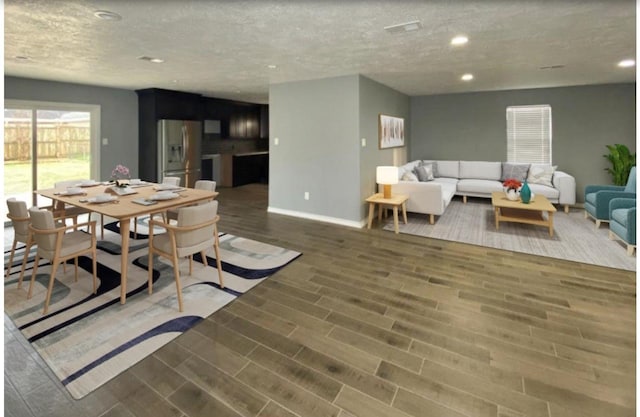 dining space featuring a textured ceiling and dark wood-type flooring