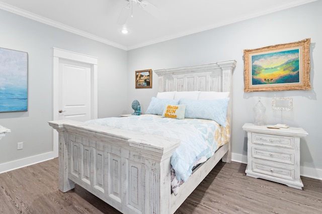 bedroom with ceiling fan, wood-type flooring, and ornamental molding