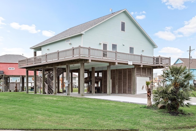 rear view of property featuring a carport, a garage, a yard, and a deck