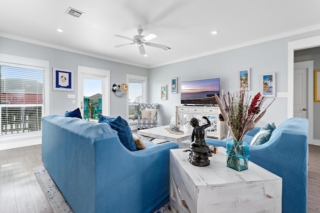 living room featuring hardwood / wood-style floors, ceiling fan, and ornamental molding