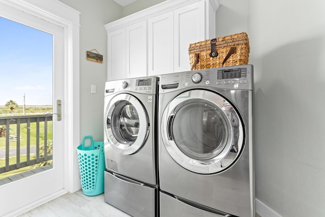 laundry area featuring cabinets and separate washer and dryer