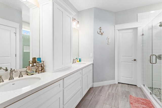 bathroom with vanity and a shower with shower door