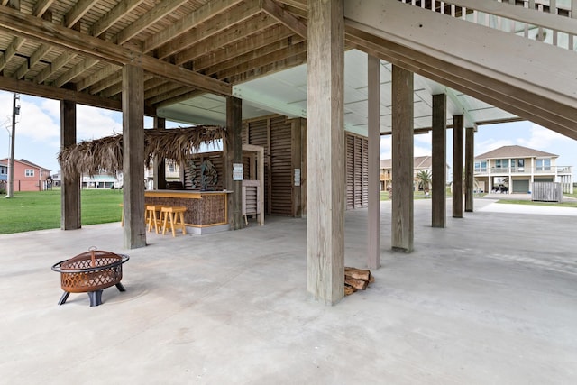 view of patio / terrace with an outdoor bar and a fire pit