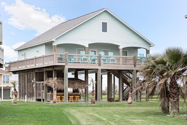 back of house featuring a lawn and exterior bar