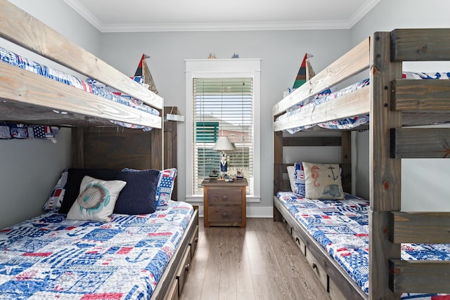 bedroom featuring wood-type flooring and ornamental molding