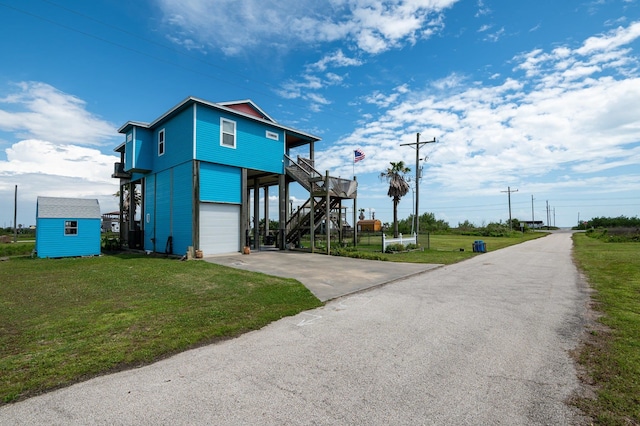 exterior space with a garage, a yard, and a shed