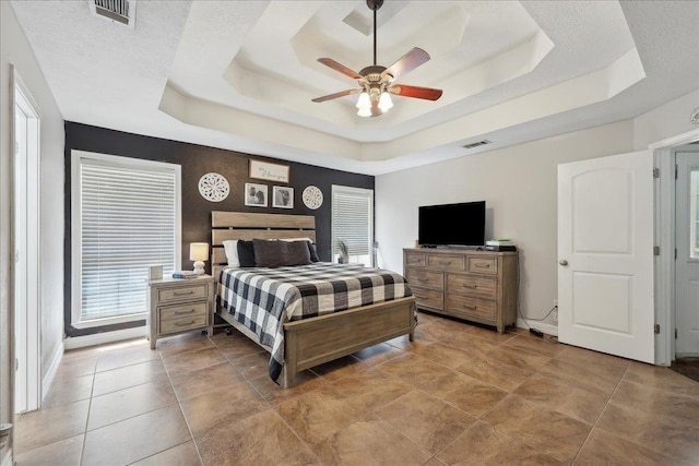 265 Callie Ln, Orange, TX 77632 - bedroom featuring a tray ceiling, baseboards, and ceiling fan