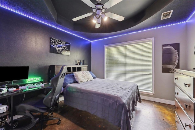 265 Callie Ln, Orange, TX 77632 - bedroom with baseboards, finished concrete floors, a desk, ceiling fan, and multiple windows