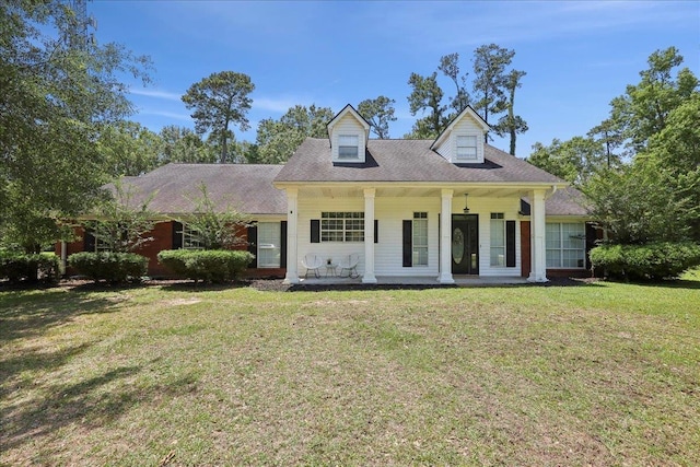 265 Callie Ln, Orange, TX 77632 - cape cod home featuring a front lawn and covered porch
