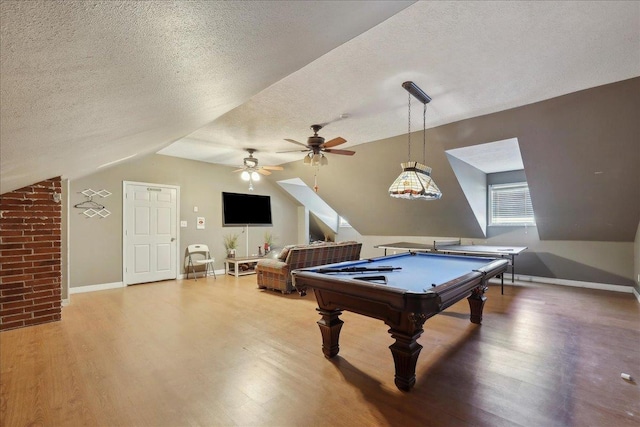 265 Callie Ln, Orange, TX 77632 - playroom featuring vaulted ceiling, light wood finished floors, billiards table, a textured ceiling, and baseboards