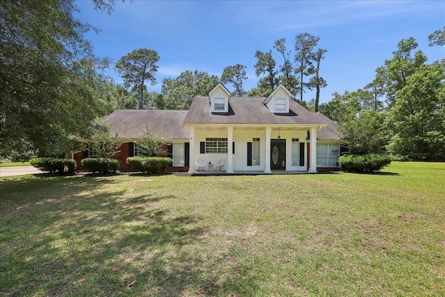 265 Callie Ln, Orange, TX 77632 - cape cod home with a front yard and a porch