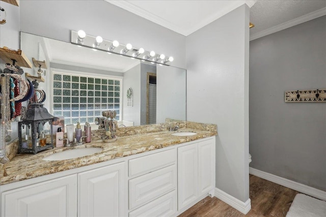265 Callie Ln, Orange, TX 77632 - bathroom with wood finished floors, crown molding, double vanity, and baseboards