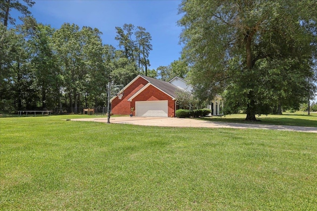 265 Callie Ln, Orange, TX 77632 - view of property exterior featuring concrete driveway, a yard, brick siding, and a garage
